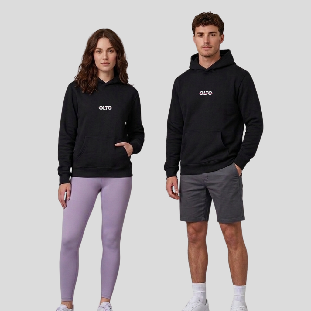 Male and female models wearing the OLTO Relaxed Hoodie in Black to demonstrate the versatile unisex relaxed fit and streetwear styling.