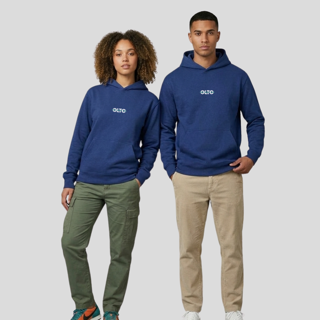 Male and female models wearing the OLTO Relaxed Hoodie in Cobalt to demonstrate the versatile unisex relaxed fit and streetwear styling.
