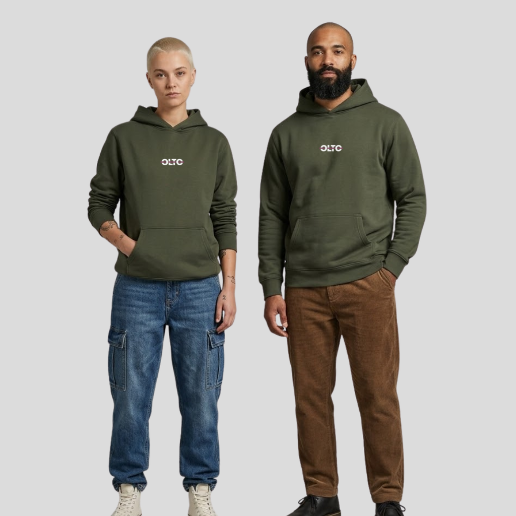 Male and female models wearing the OLTO Relaxed Hoodie in Cypress to demonstrate the versatile unisex relaxed fit and streetwear styling.