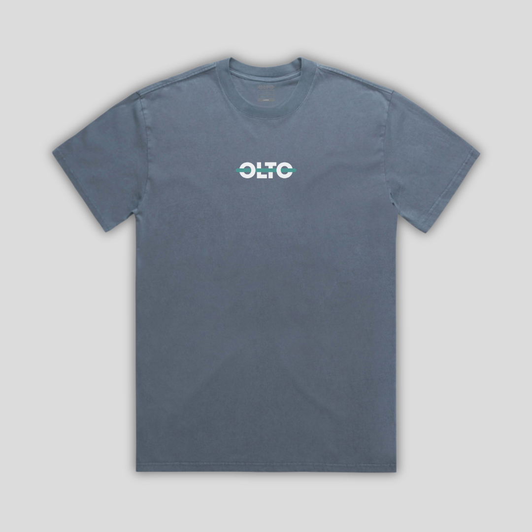 Front view flat lay of OLTO Relaxed T-Shirt in Faded Indigo showing the signature Colourbolt chest logo and premium heavyweight fabric texture.