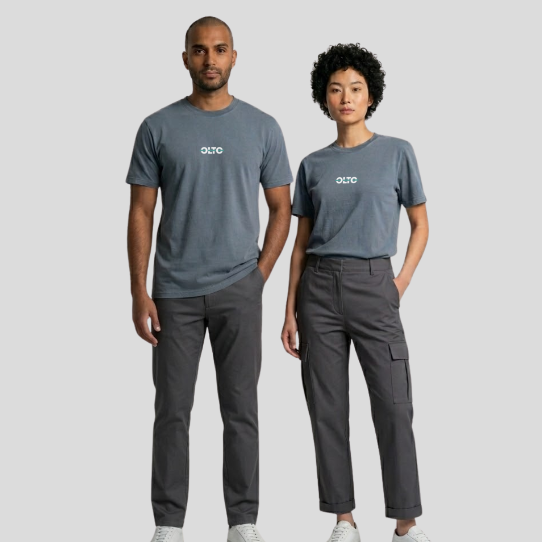 Male and female models wearing the OLTO Relaxed T-Shirt in Faded Indigo to demonstrate the versatile unisex relaxed fit and streetwear styling.