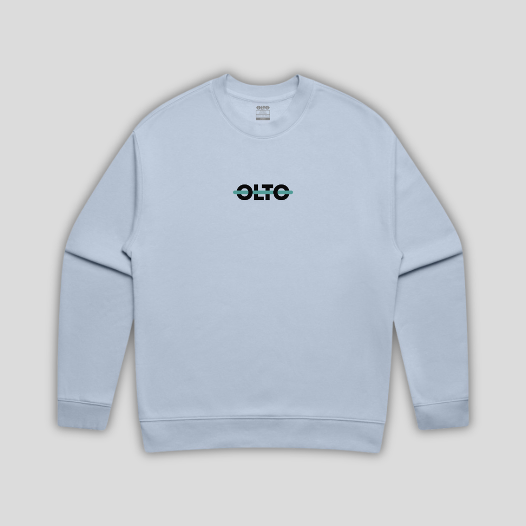 Front view flat lay of OLTO Sweater in Powder showing the signature ColourBolt chest logo and premium heavyweight fabric texture.