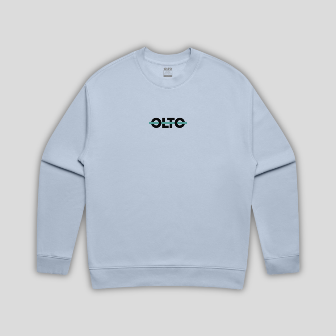 Front view flat lay of OLTO Sweater in Powder showing the signature ColourBolt chest logo and premium heavyweight fabric texture.