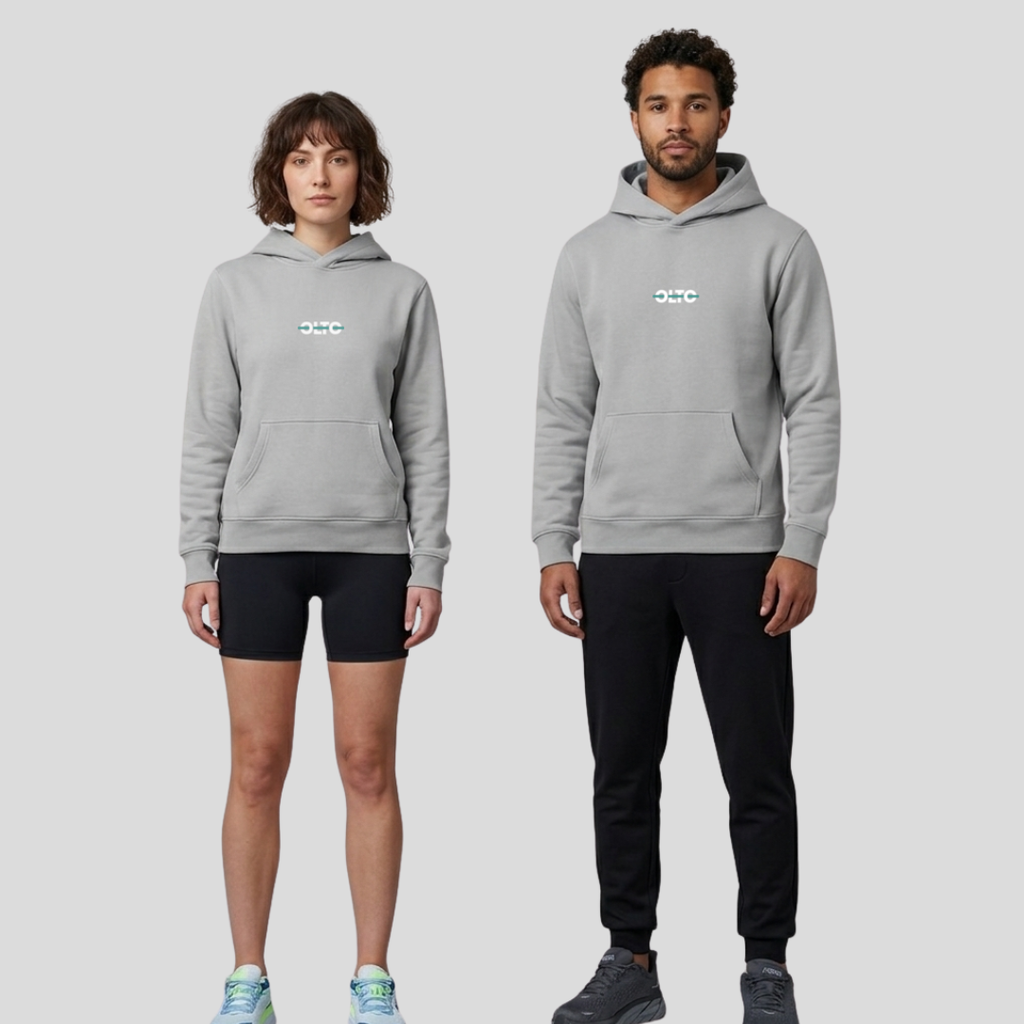 Male and female models wearing the OLTO Relaxed Hoodie in Storm to demonstrate the versatile unisex relaxed fit and streetwear styling.