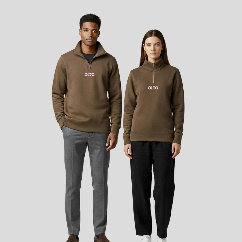 Male and female models wearing the OLTO Half Zip in Walnut to demonstrate the versatile unisex relaxed fit and streetwear styling.